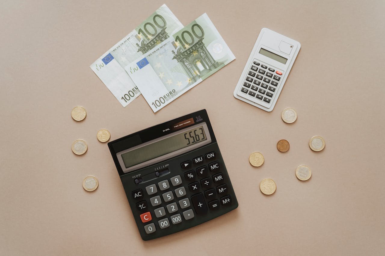 Flat lay of calculators and Euro currency, depicting financial calculations and budget management.